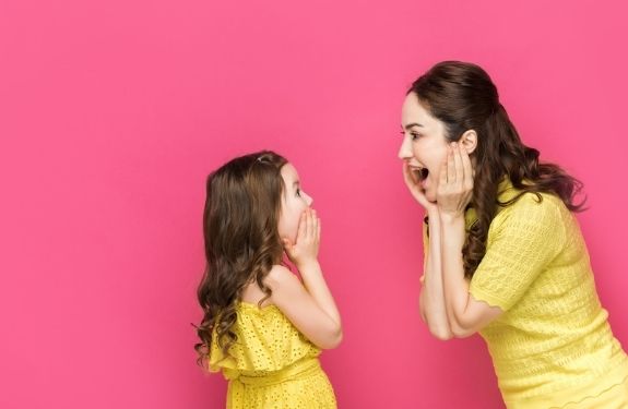 mom and daughter looking at each other shocked