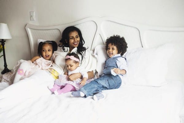 Mother and three children in bed