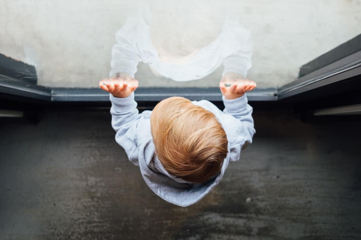 Toddler looking out the window