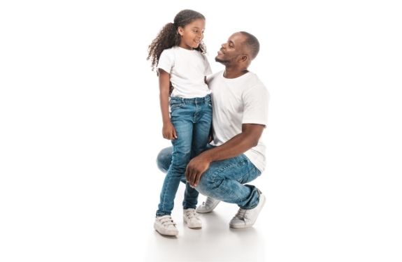 daughter and father smiling at each other