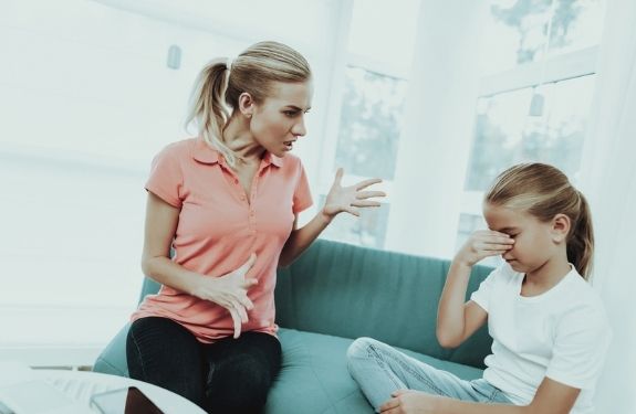 mom yelling at daughter who looks sad